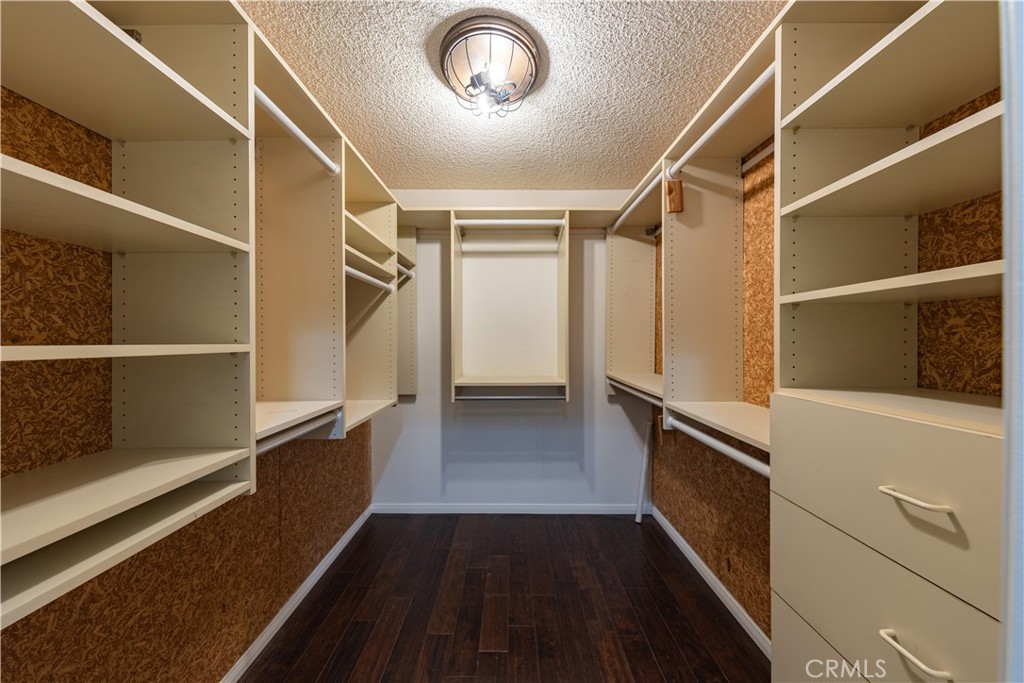 6242 Riviera Circle Long Beach, CA 90815 - Photo 14 of 29 a view of walk in closet with wooden floor and fan