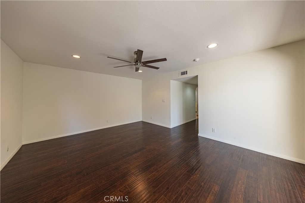 6242 Riviera Circle Long Beach, CA 90815 - Photo 17 of 29 a view of a room with wooden floor and a ceiling fan