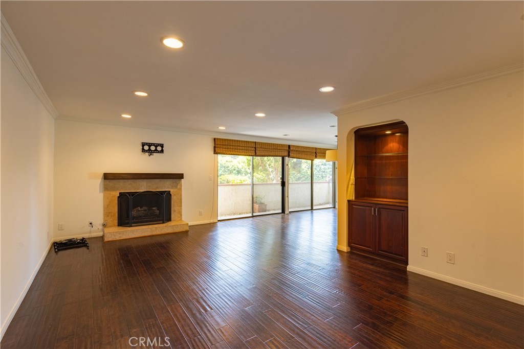 6242 Riviera Circle Long Beach, CA 90815 - Photo 5 of 29 an empty room with wooden floor fireplace and windows