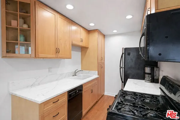 a kitchen with a sink stove and refrigerator