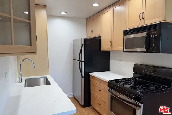 a kitchen with a refrigerator stove and microwave