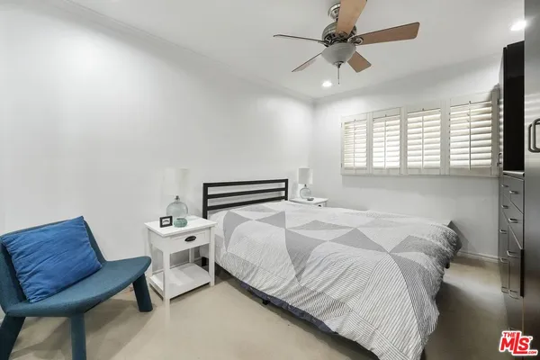 a bedroom with a bed and a chair