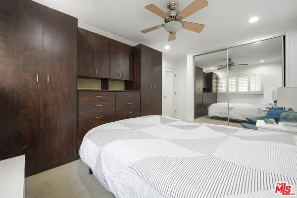 a spacious bedroom with a bed and a chandelier