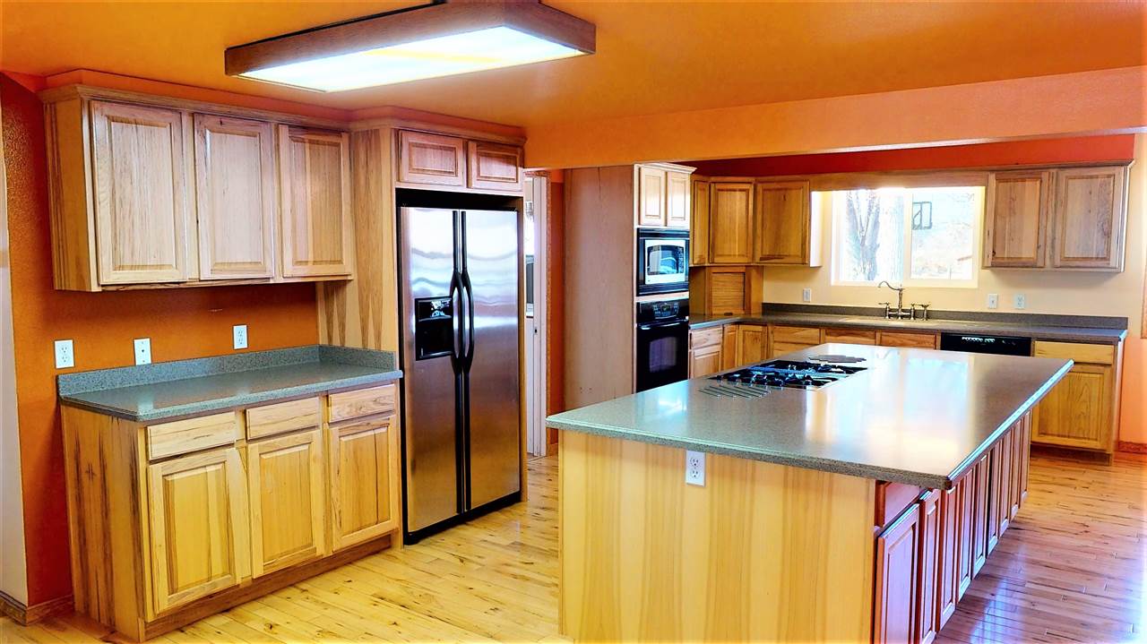 945 23 Road Grand Junction, CO 81505 - Photo 4 of 27 a kitchen with stainless steel appliances granite countertop a refrigerator sink and cabinets
