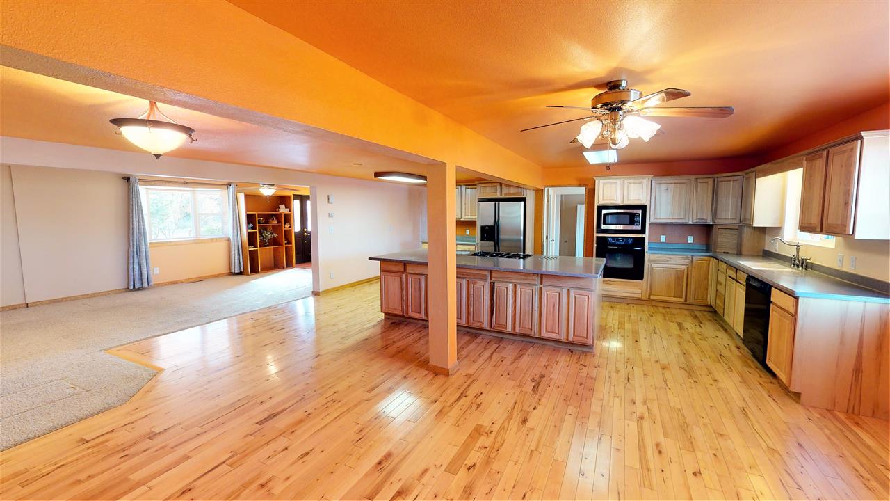 945 23 Road Grand Junction, CO 81505 - Photo 5 of 27 a large kitchen with stainless steel appliances kitchen island granite countertop a large counter top and appliances