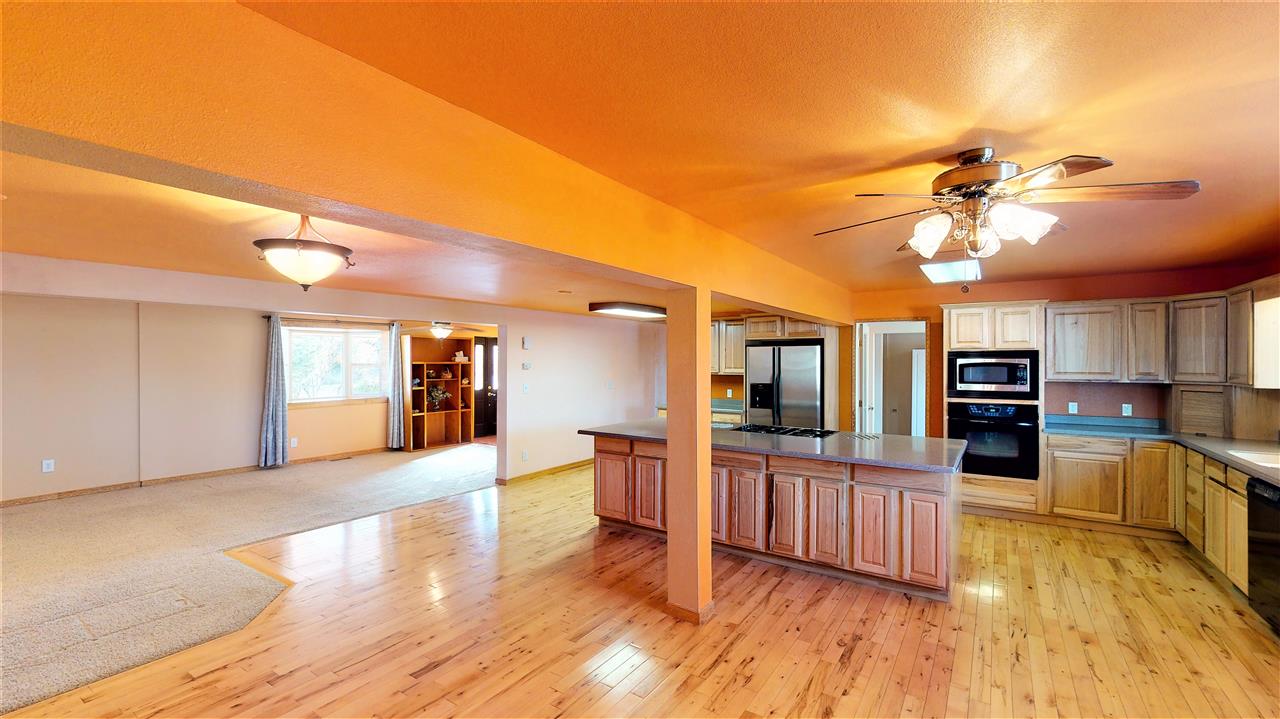 945 23 Road Grand Junction, CO 81505 - Photo 6 of 27 a view of a living room a kitchen and a wooden floor