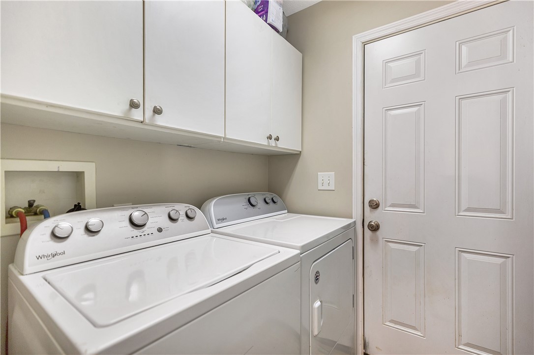 3338 Centerville Road Anderson, SC 29625 - Photo 21 of 28 This dedicated laundry area offers practical convenience with essential appliances and overhead cabinetry.