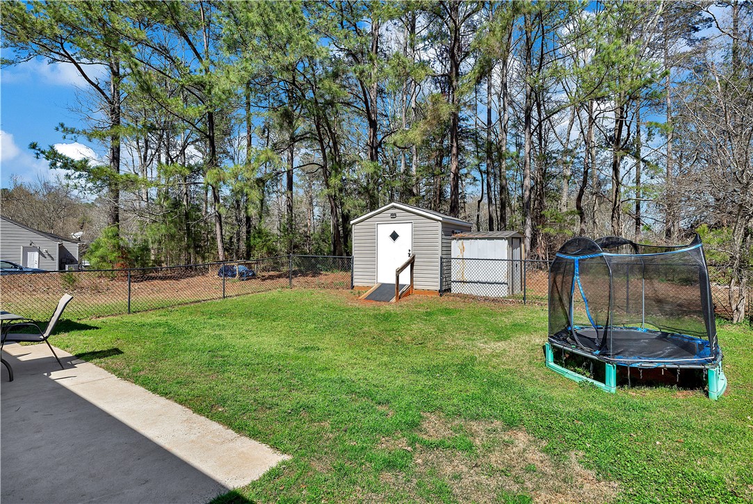 3338 Centerville Road Anderson, SC 29625 - Photo 25 of 28 This spacious backyard provides ample room for outdoor activities and features convenient storage solutions.