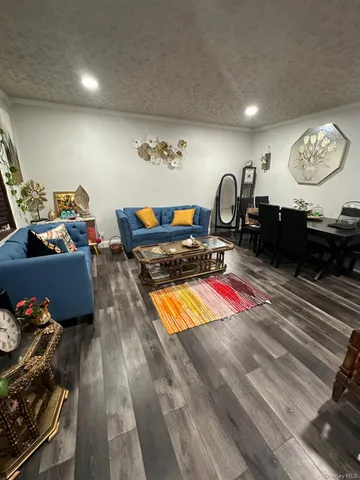 a living room with furniture a rug and a flat screen tv
