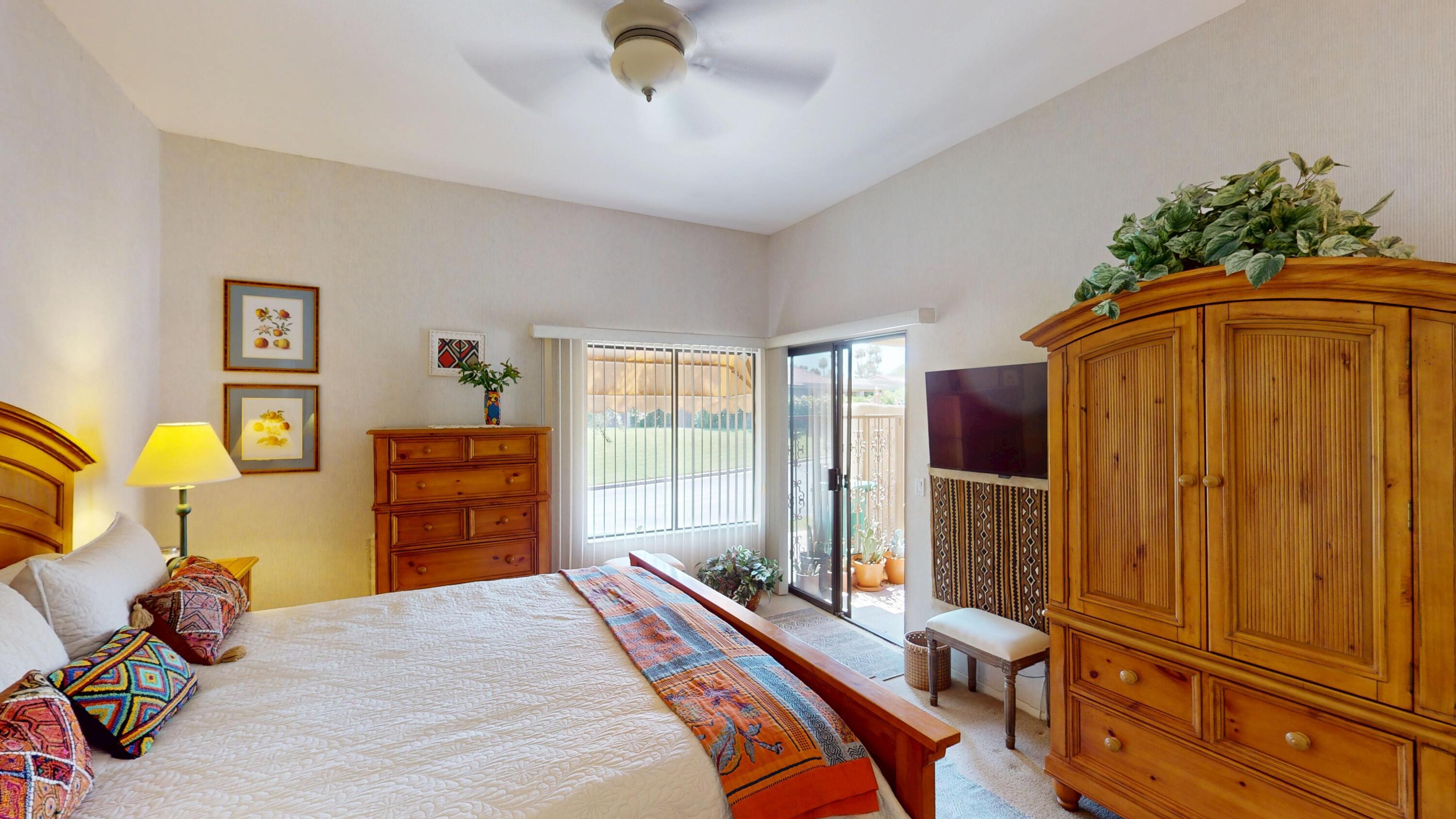 72350 Rim Drive Palm Desert, CA 92260 - Photo 12 of 30 a bedroom with a bed and a chandelier