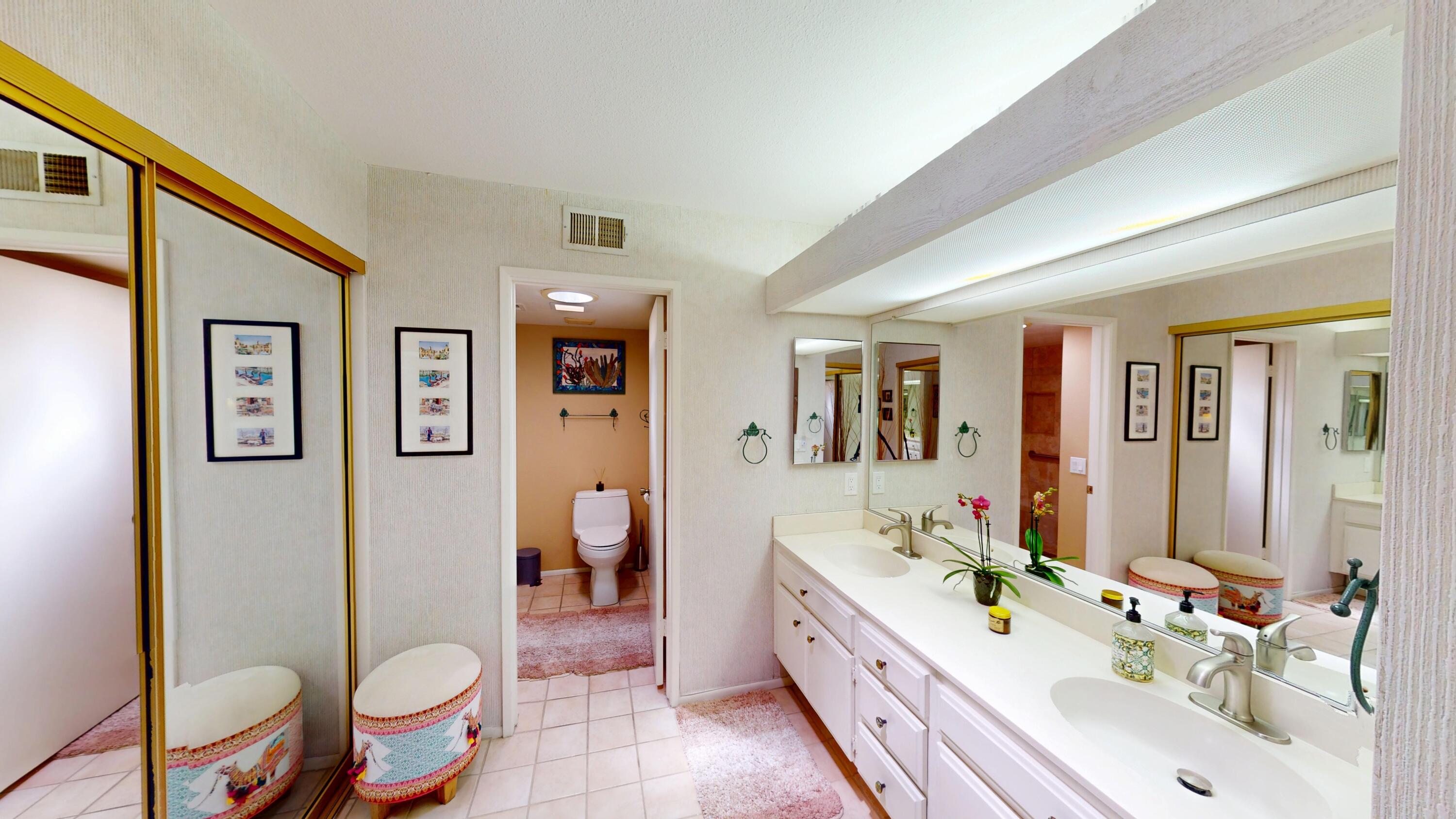 72350 Rim Drive Palm Desert, CA 92260 - Photo 16 of 30 a bathroom with a sink vanity mirror and toilet