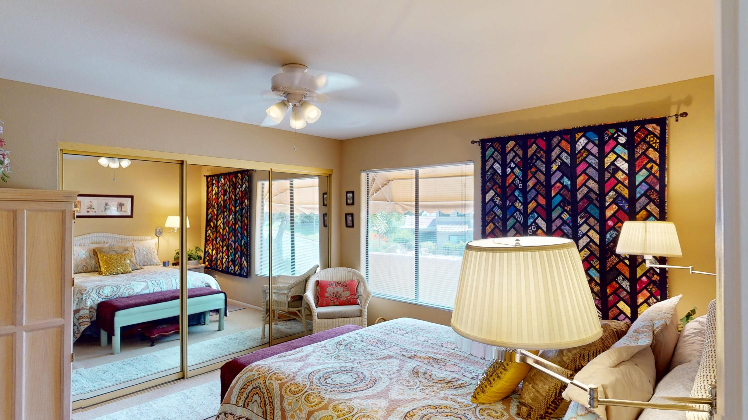 72350 Rim Drive Palm Desert, CA 92260 - Photo 17 of 30 a bedroom with a bed and wooden floor