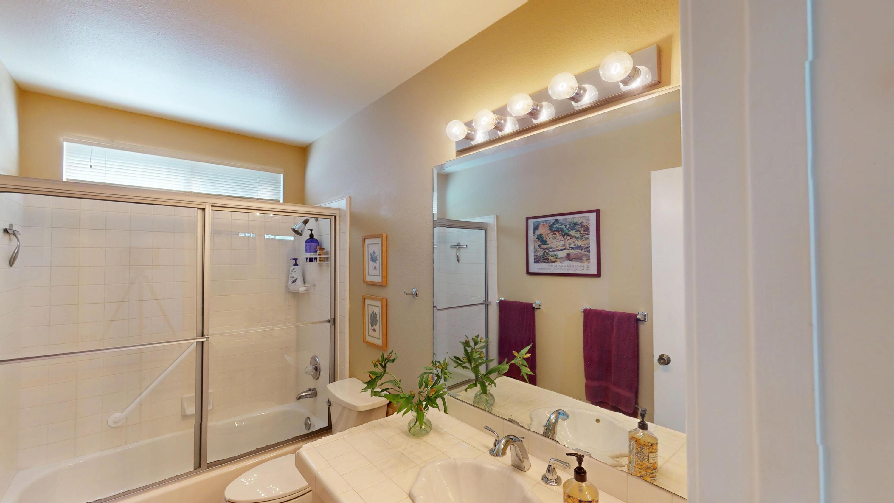 72350 Rim Drive Palm Desert, CA 92260 - Photo 19 of 30 a bathroom with a granite countertop sink mirror and a shower