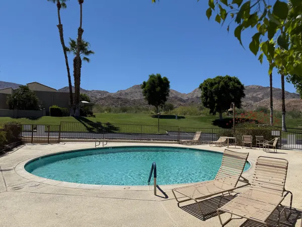 a view of a swimming pool with a table and chairs
