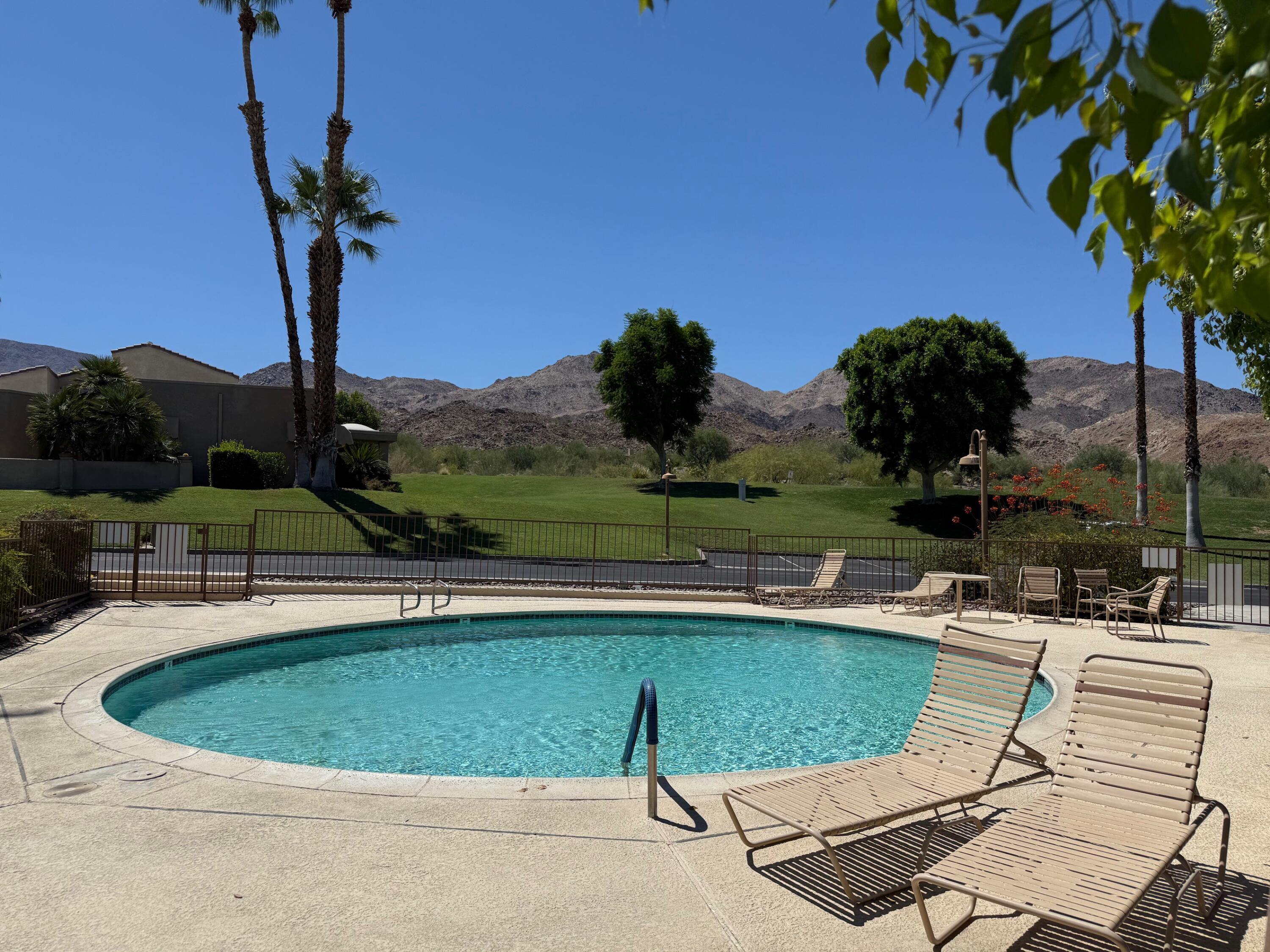 72350 Rim Drive Palm Desert, CA 92260 - Photo 27 of 30 a view of a swimming pool with a table and chairs
