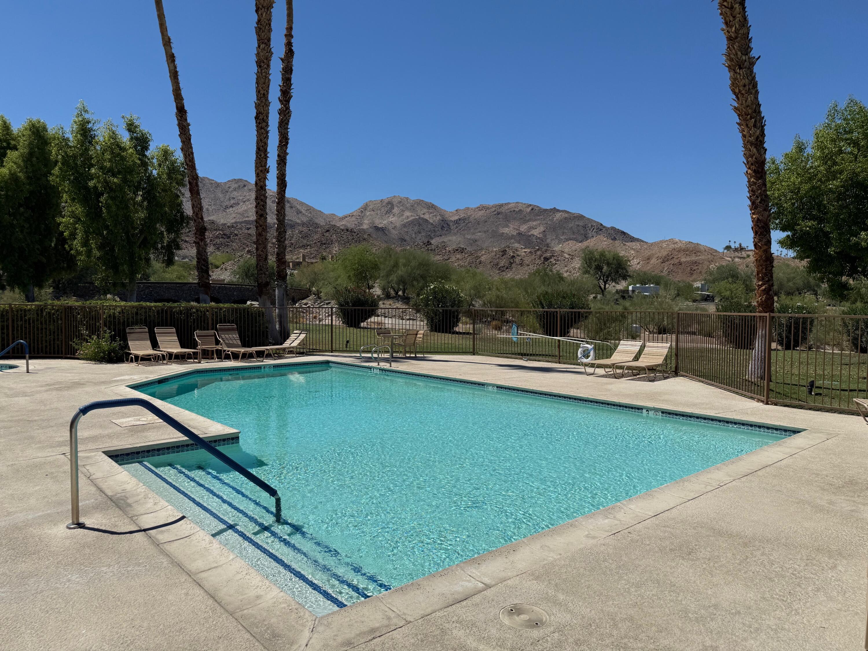 72350 Rim Drive Palm Desert, CA 92260 - Photo 28 of 30 a view of a swimming pool with a patio and a yard