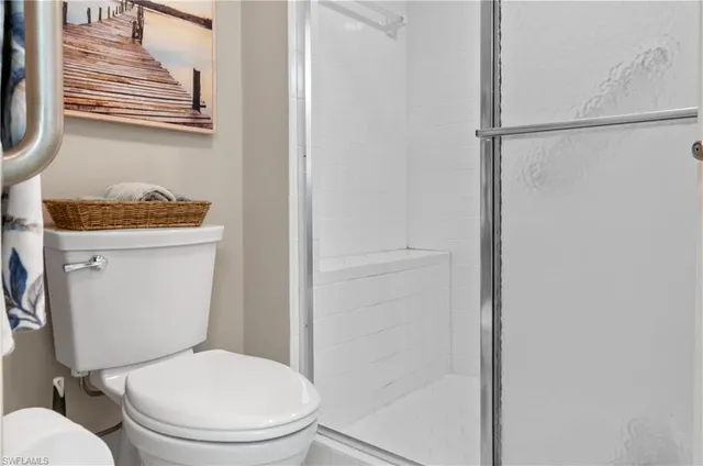 a white toilet sitting next to a bathroom sink