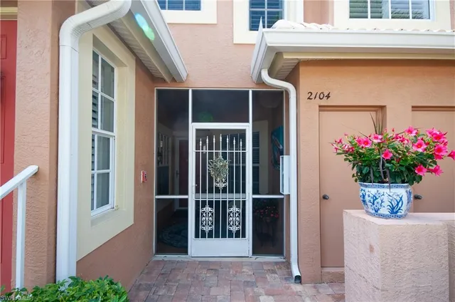 a view of a house with a potted plant and a window