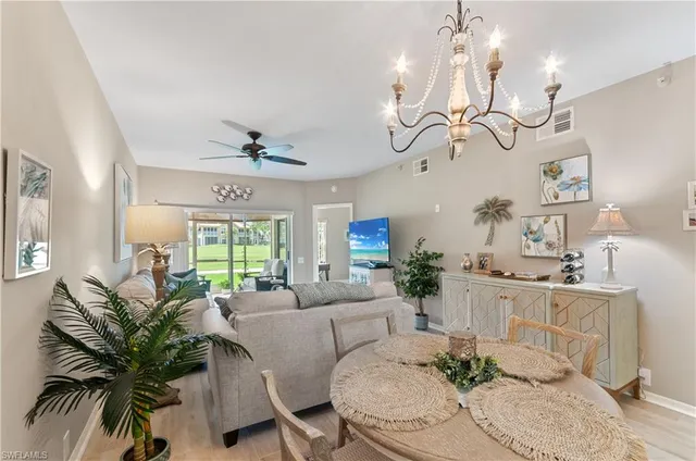 a living room with furniture chandelier and a chandelier