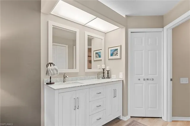 a bathroom with a double vanity sink and mirror