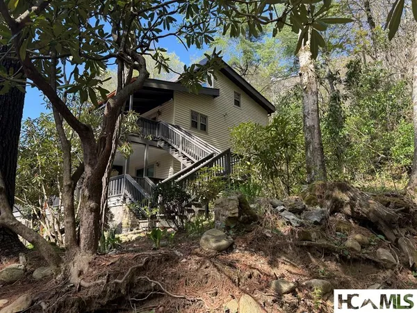 a view of a house with a tree