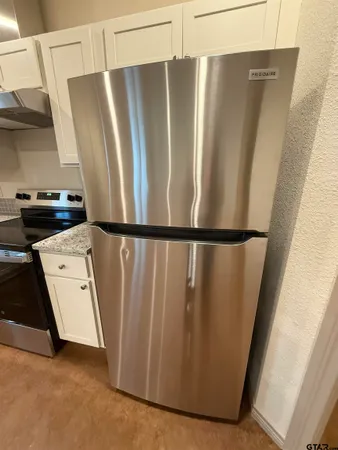 a view of a refrigerator in kitchen