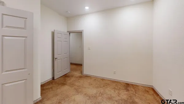 a view of a hallway with wooden floor and closet
