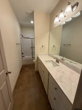 a bathroom with a double vanity sink and a mirror