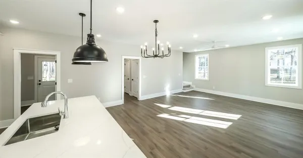 a view of a kitchen with wooden floor and a sink