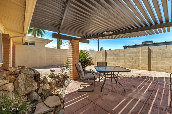 a patio with table and chairs