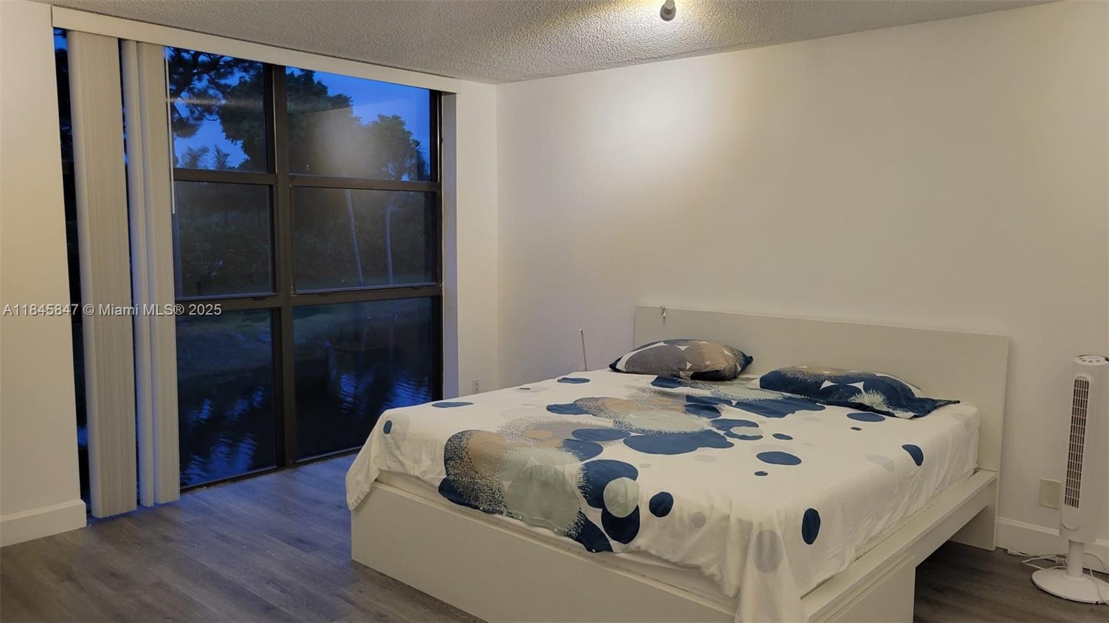 6562 Boca Del Mar Drive, Unit 225 Boca Raton, FL 33433 - Photo 12 of 24 a bedroom with a bed and wooden floor