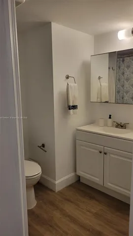 a view of a room with a wooden door and staircase