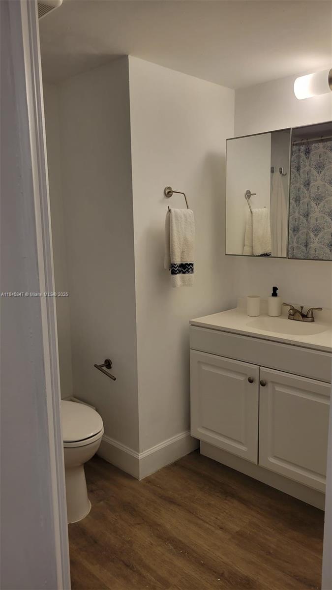 6562 Boca Del Mar Drive, Unit 225 Boca Raton, FL 33433 - Photo 16 of 24 a bathroom with a granite countertop sink toilet and mirror