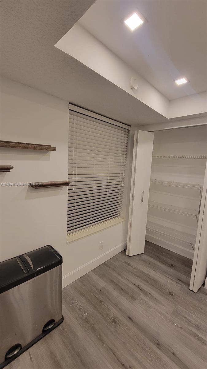 6562 Boca Del Mar Drive, Unit 225 Boca Raton, FL 33433 - Photo 17 of 24 a view of an empty room with wooden floor and a window