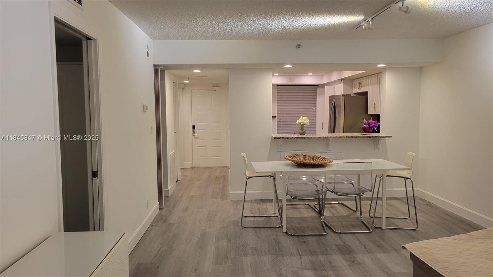 6562 Boca Del Mar Drive, Unit 225 Boca Raton, FL 33433 - Photo 7 of 24 a view of a dining room with furniture and wooden floor
