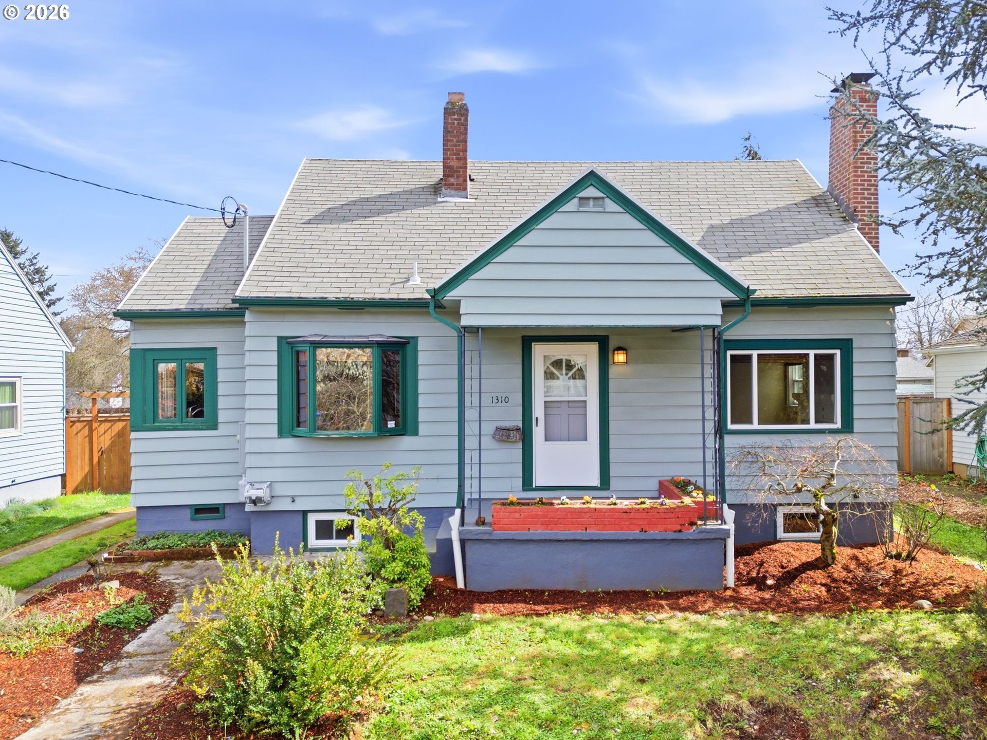 a front view of a house with a yard outdoor seating and garage