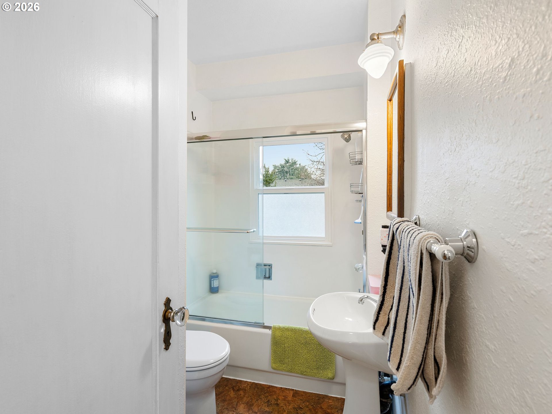 1310 Northeast 70th Avenue Portland, OR 97213 - Photo 17 of 30 a bathroom with a sink a toilet and a mirror