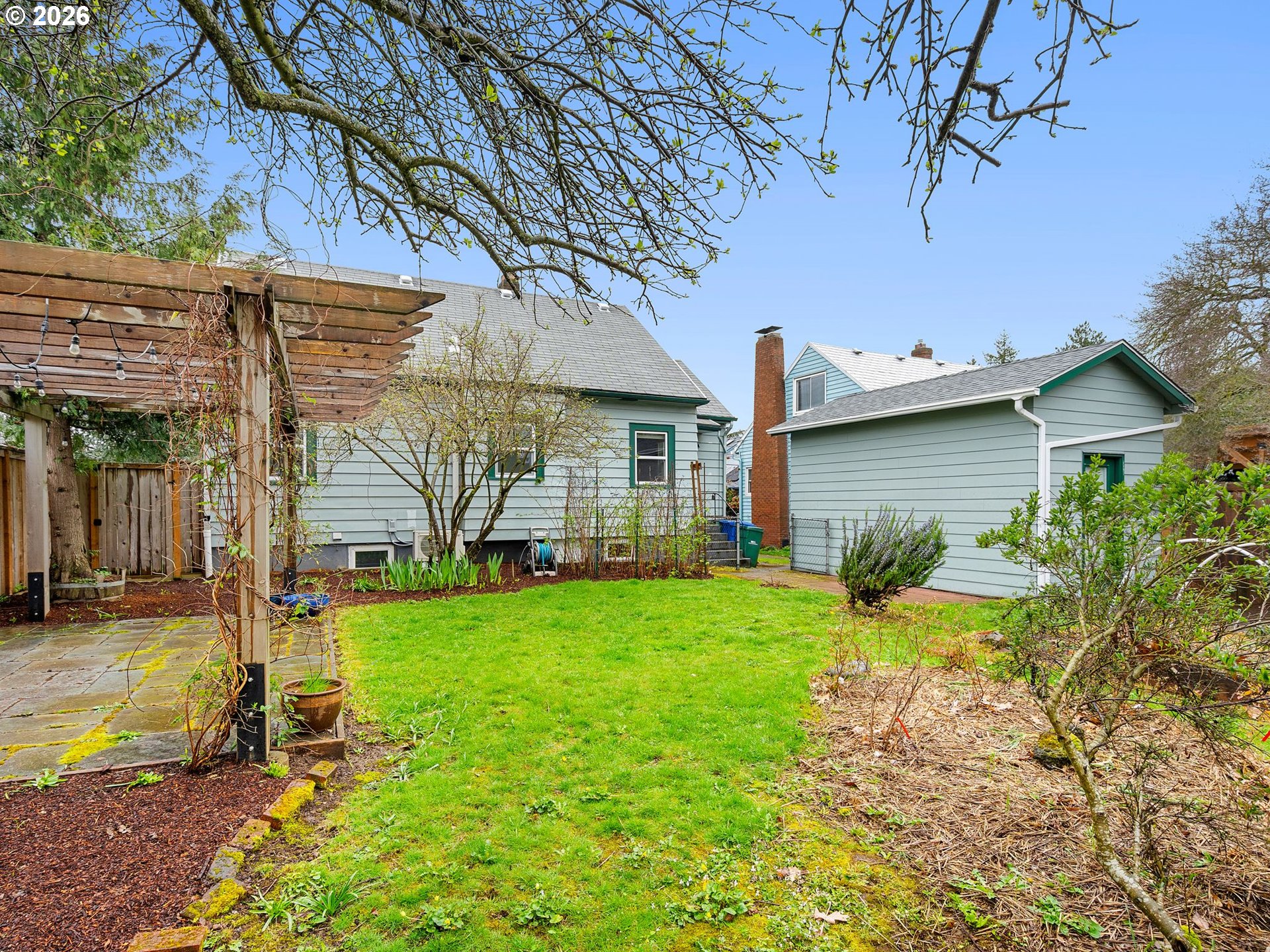 1310 Northeast 70th Avenue Portland, OR 97213 - Photo 25 of 30 a view of a backyard with plants and large tree