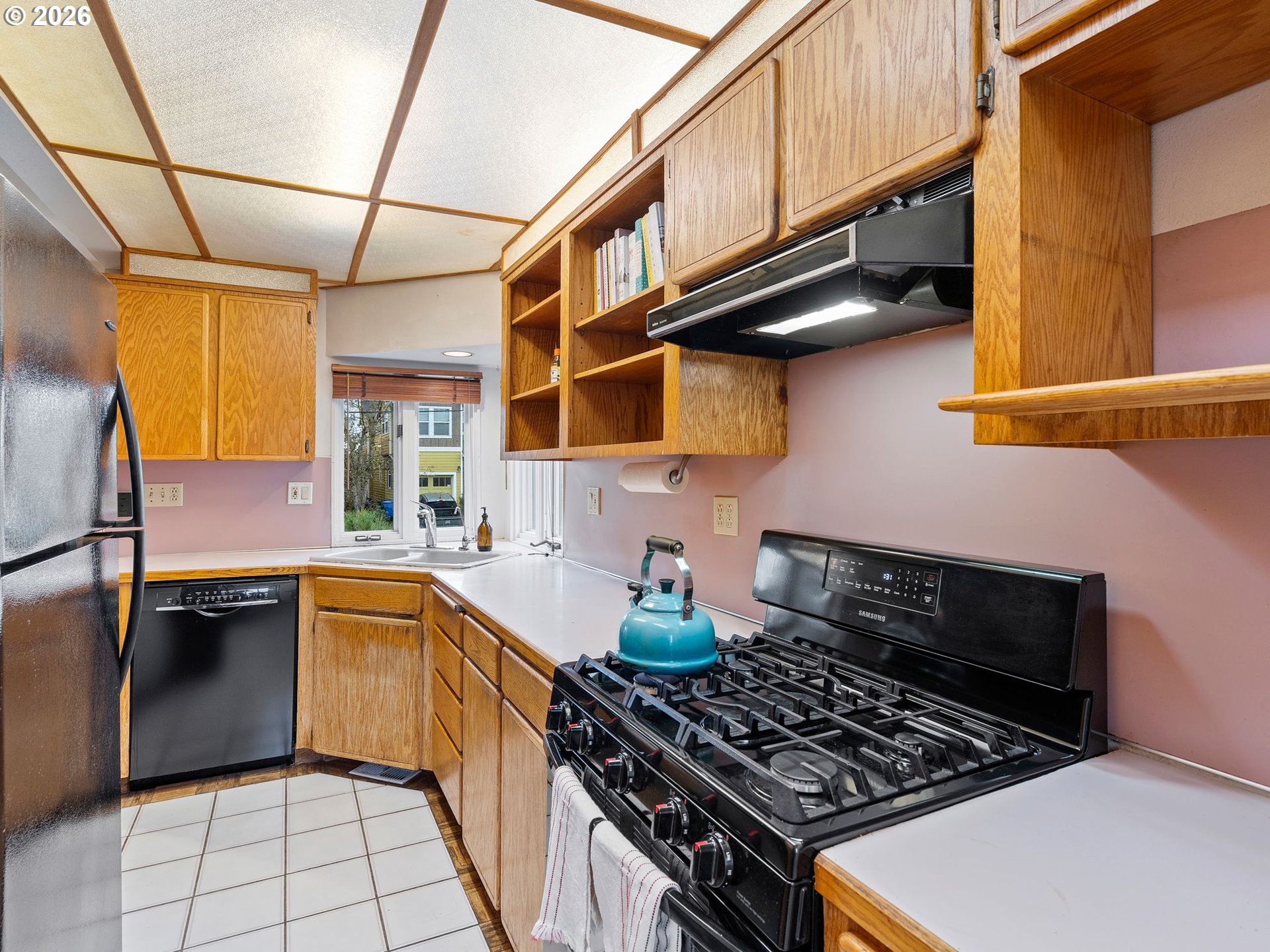 1310 Northeast 70th Avenue Portland, OR 97213 - Photo 10 of 30 a kitchen with stainless steel appliances granite countertop a stove and a sink