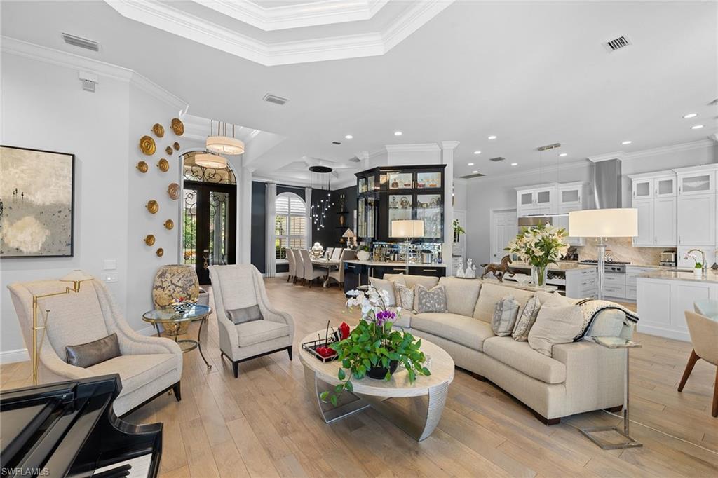 7837 Classics Drive Naples, FL 34113 - Photo 11 of 50 Living room featuring ornamental molding, light wood finished floors, french doors, and recessed lighting