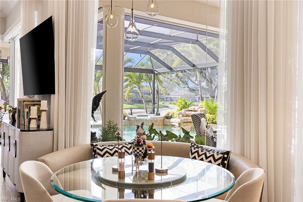 7837 Classics Drive Naples, FL 34113 - Photo 15 of 50 Dining area featuring a sunroom and healthy amount of natural light