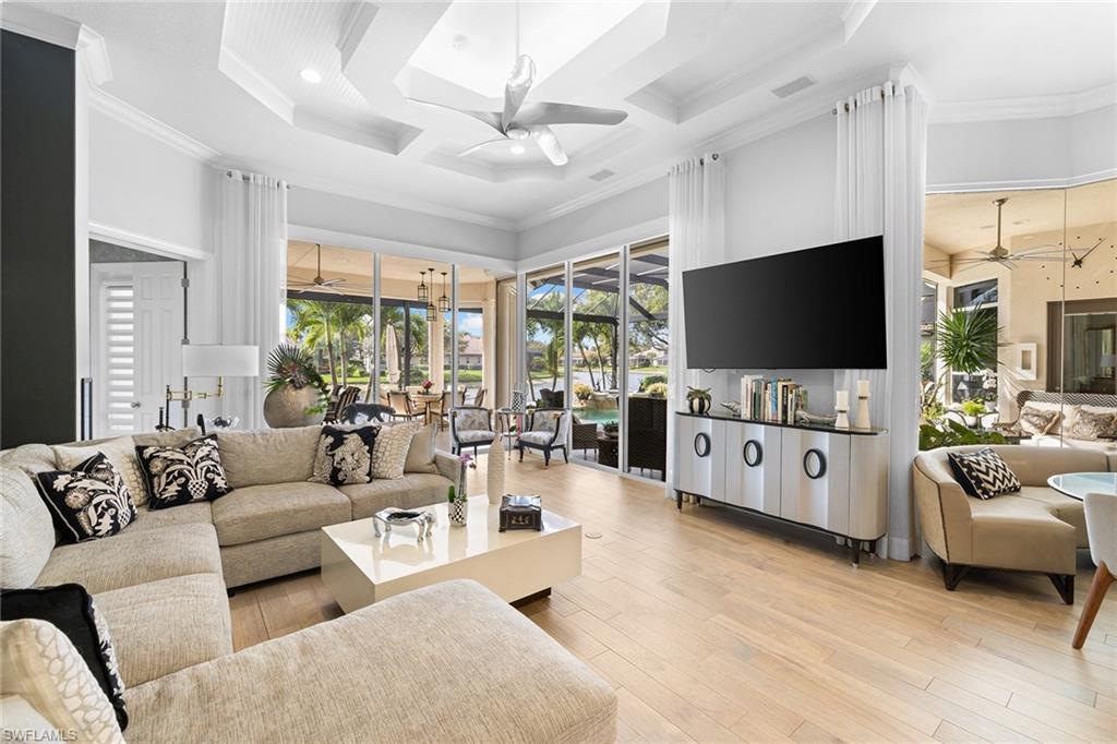 7837 Classics Drive Naples, FL 34113 - Photo 23 of 50 Living area with a ceiling fan, coffered ceiling, a towering ceiling, recessed lighting, and light wood finished floors