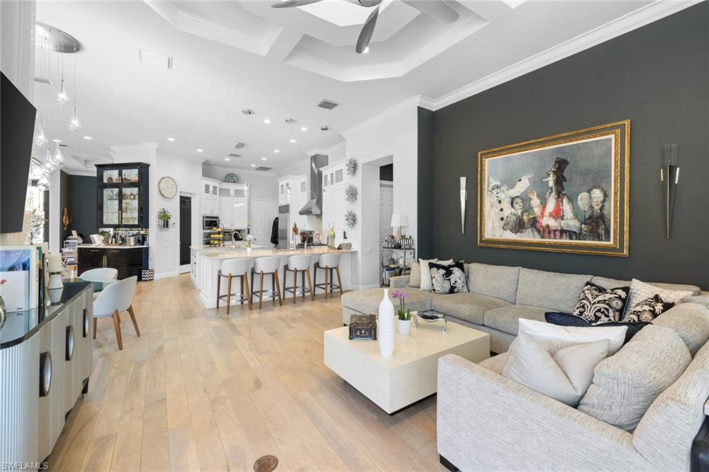 7837 Classics Drive Naples, FL 34113 - Photo 25 of 50 Living area featuring ceiling fan, light wood-style flooring, crown molding, and recessed lighting