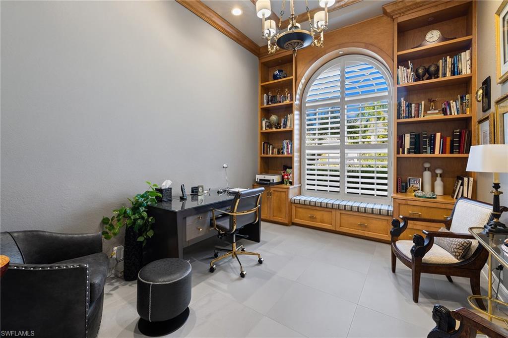 7837 Classics Drive Naples, FL 34113 - Photo 26 of 50 Office area with a chandelier, built in features, and crown molding
