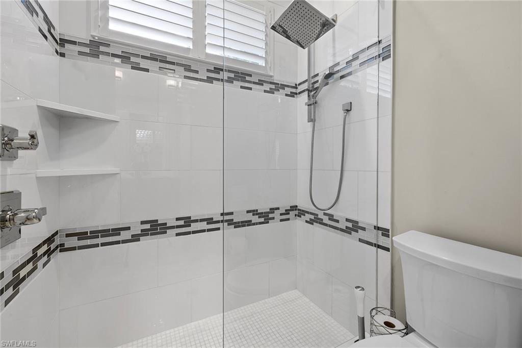 7837 Classics Drive Naples, FL 34113 - Photo 30 of 50 Bathroom featuring a stall shower and toilet