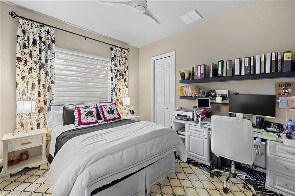 7837 Classics Drive Naples, FL 34113 - Photo 31 of 50 Bedroom featuring a ceiling fan and built in study area