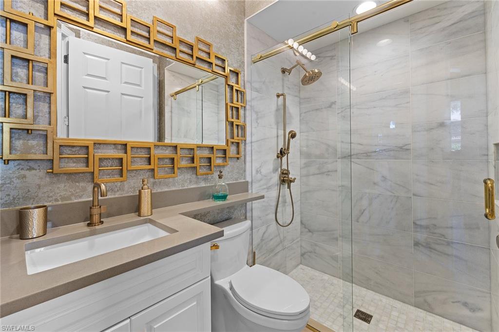 7837 Classics Drive Naples, FL 34113 - Photo 32 of 50 Full bathroom with a shower stall and vanity