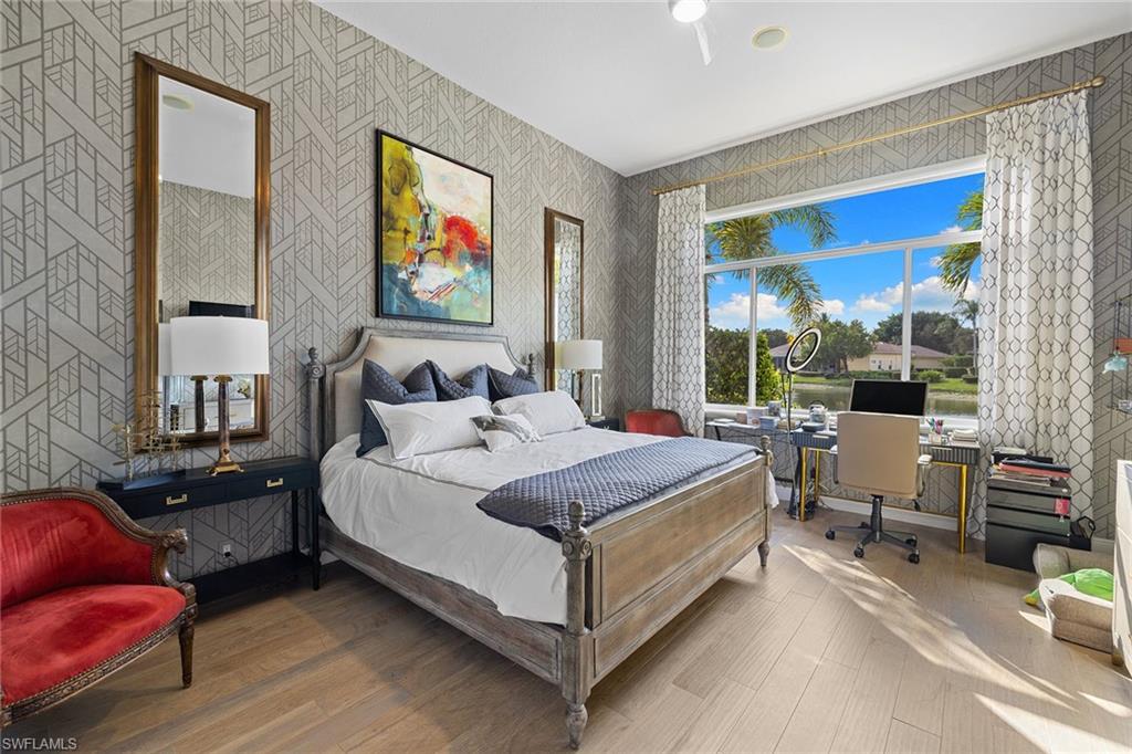 7837 Classics Drive Naples, FL 34113 - Photo 33 of 50 Bedroom with wood finished floors, a desk, and wallpapered walls