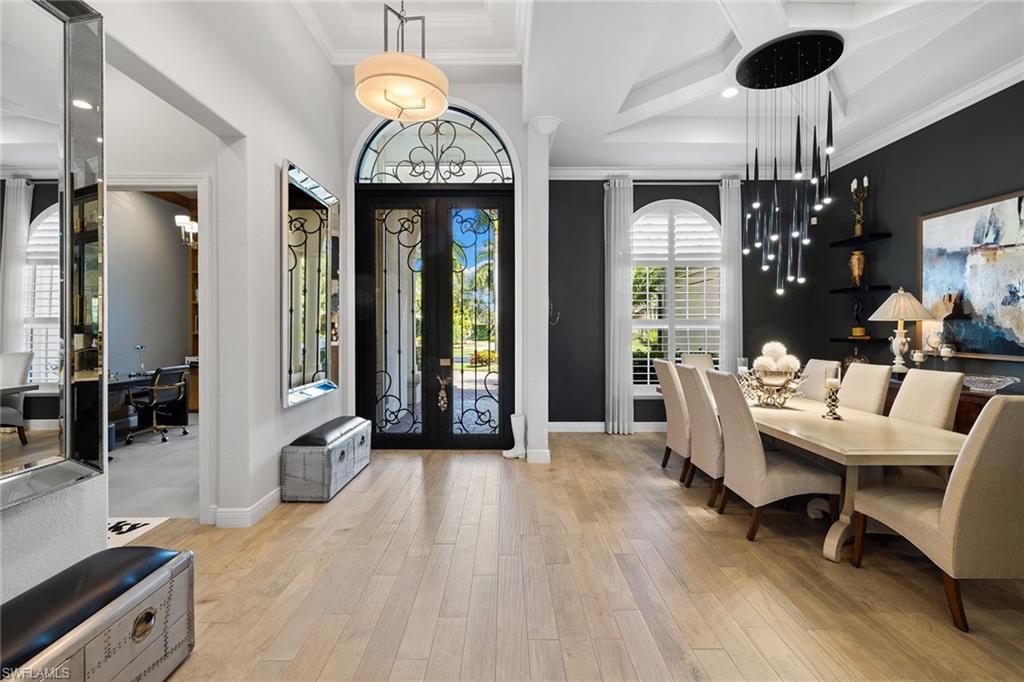 7837 Classics Drive Naples, FL 34113 - Photo 4 of 50 Foyer entrance featuring french doors, light wood-style floors, recessed lighting, and crown molding
