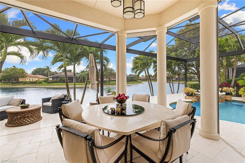 7837 Classics Drive Naples, FL 34113 - Photo 41 of 50 Sunroom with a patio, outdoor dining space, an outdoor hangout area, and a water view